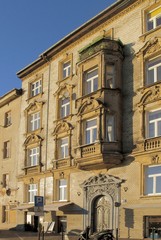 pretty decorated facades of old buildings in Krakow center