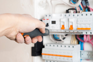 electrician attaches a wire