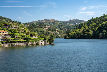 Fototapeta na wymiar Modern homes and terraces come down to riverbank of Douro river near Viseu in Portugal