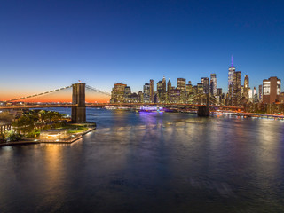 Fototapeta na wymiar New York City downtown buildings skyline Brooklyn Bridge evening night