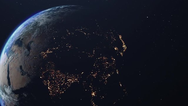Space view of the planet Earth. Sunlight gradually fills the surface of the planet, changing night to day. Bright night lights of cities are replaced by cloudy day views.