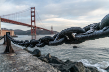Closeup Of Large Chain In San Francisco With The Golden Gate Bridge In Background