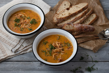 Vegan, gluten free corngrits soup with carrots and herbs, topped with crispy onions