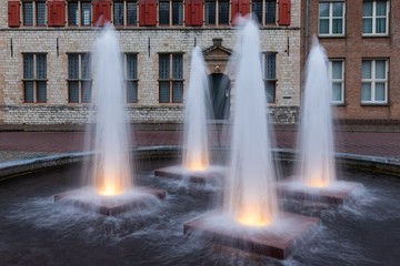 Four illuminated fountains in medieval city Middelburg, The Netherlands