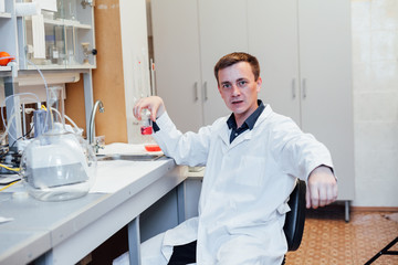 male scientist conducts chemical experiments with liquids in science lab