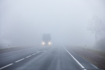 Truck on the road in the fog - Powered by Adobe
