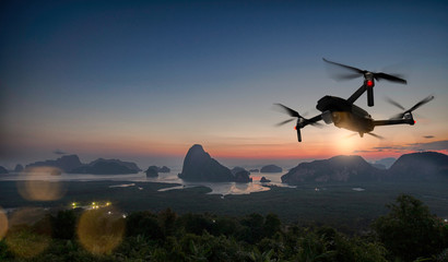 Fototapeta na wymiar Drone quad copter with high resolution digital camera on the sky mountain and city background.