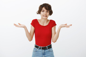 Bummer oops. Confused awkward attractive caucasian woman short haircut smiling sorry guilty unaware...