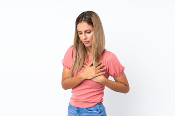 Fototapeta premium Young blonde woman over isolated white background having a pain in the heart