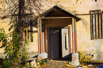 an old house with a porch and boarded-up Windows