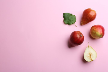 Ripe juicy pears on pink background, flat lay. Space for text