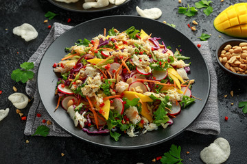 Crab salad with vegetables, radish, carrots, mango, pine nuts and prawn crackers