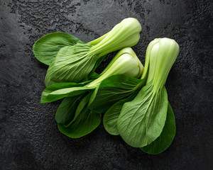 Pak Choi Chinese Cabbage on rustic black background