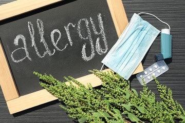 Ragweed plant (Ambrosia genus) medication and chalkboard with word 