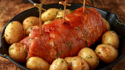 Ready to cook prune, rosemy and garlic stuffed pork fillet with baby potatoes