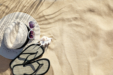 Fototapeta na wymiar Flat lay composition with different beach accessories on sand. Space for text
