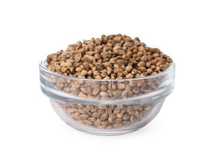 Glass bowl of hemp seeds on white background