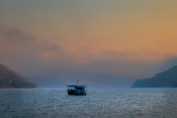 Boat on Danube river at sunrise near the Donji Milanovac in Serbia