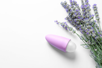Obraz na płótnie Canvas Female deodorant and lavender flowers on white background, top view