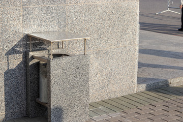 Stone trash bin. Free space for text and content. Concept of garbage collection in an urban environment.