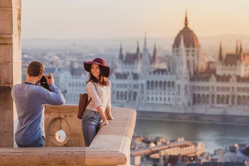 Peel and stick wall murals Budapest Young couple take pictures of each other on the view point from Fisherman Bastion in Budapest on sunrise.