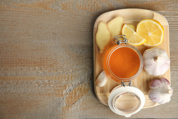 Cold remedies on wooden table, top view with space for text. Sore throat treatment
