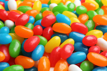 Fototapeta na wymiar Tasty colorful jelly beans as background, closeup