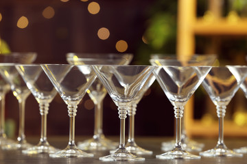 Empty martini glasses on table against blurred background
