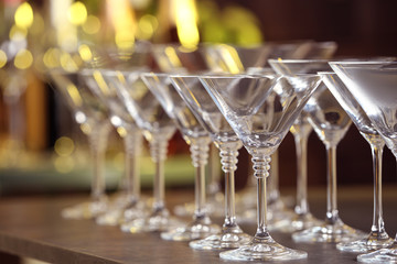 Empty martini glasses on table against blurred background