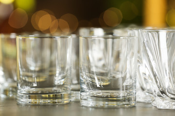 Empty glasses on table against blurred background