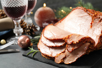 Delicious Christmas ham served on dark table, closeup