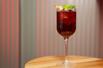 Glass of delicious cocktail with vodka on wooden table in bar. Space for text