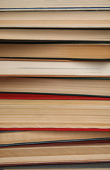 Stack of hardcover books as background, closeup