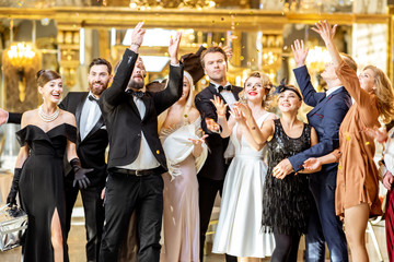Well-dressed people celebrating New Year indoors