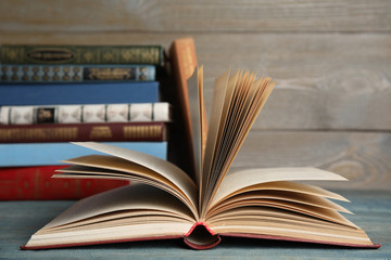 Open hardcover book on blue wooden table