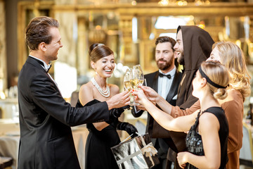 Well-dressed people celebrating New Year indoors