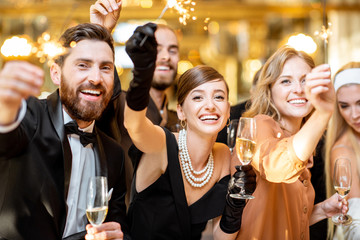 Well-dressed people celebrating New Year indoors