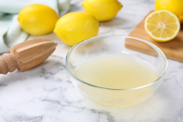 Freshly squeezed lemon juice on white marble table
