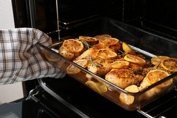 Taking delicious lemon chicken out of oven