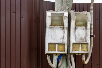 Dirty electrical shield with wires on a street pole with copy space