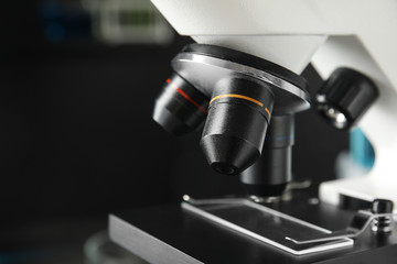 Modern microscope with different lenses in laboratory, closeup. Medical equipment