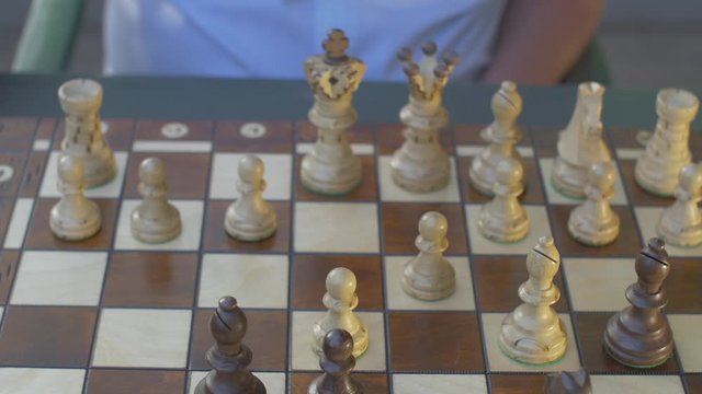 Front Top view of a chess game. Outside in garden