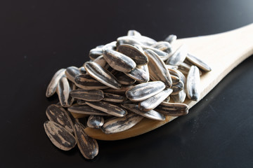Sunflower seed on wooden spoon