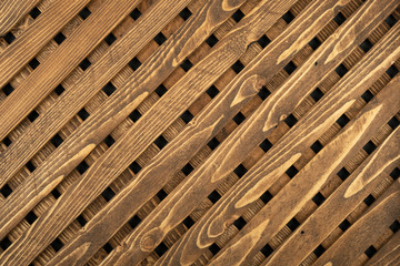 Texture of the wooden lattice. Natural wooden diagonal lattice. Close-up.