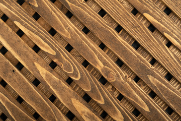 Texture of the wooden lattice. Natural wooden diagonal lattice. Close-up.