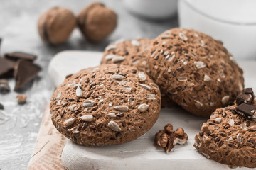 Vegan oatmeal cookies with seeds, sesame seeds and a glass of milk on the table. Healthy vegetarian food concept. Light background, beautiful decor.