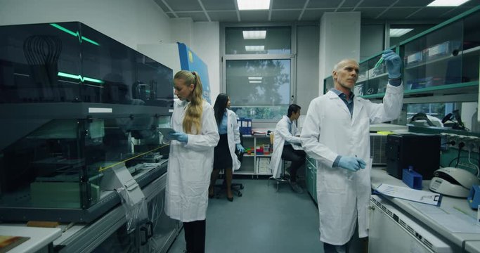 The scientists are working on a research of new pharmaceutical medicaments creation in a laboratory.