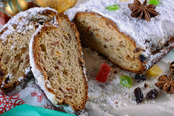 Delicious christmas pie named Stollen cut into pieces for the new year table, close up