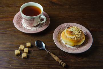  tea and bun on a wooden table