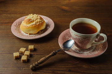  tea and bun on a wooden table1